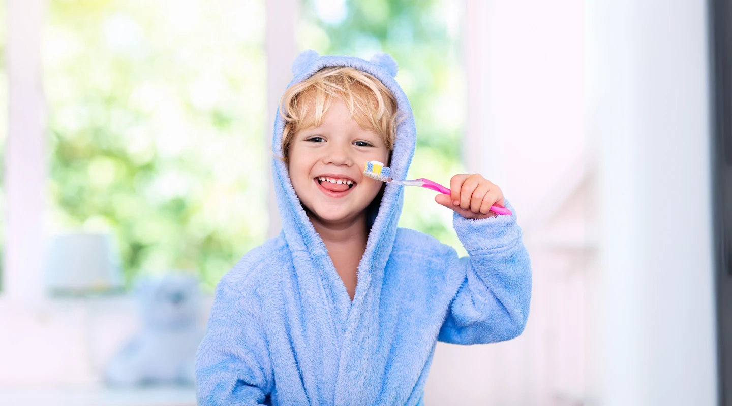 child brushing his teeth
