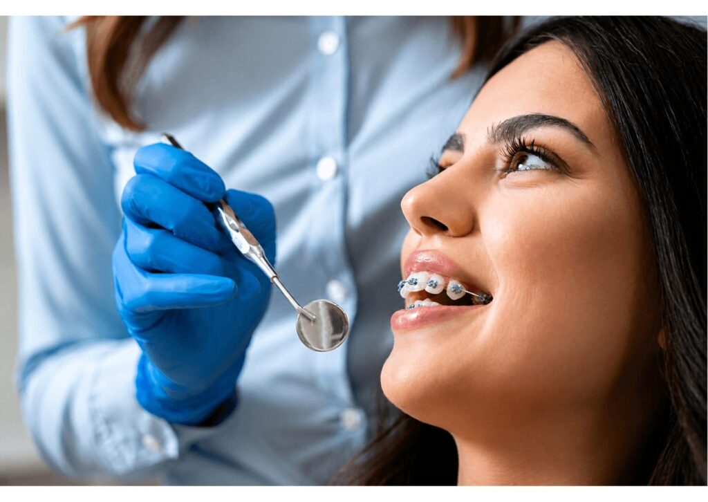 Patient with braces during dental checkup demonstrating orthodontic care and managing irritation with orthodontic wax use.