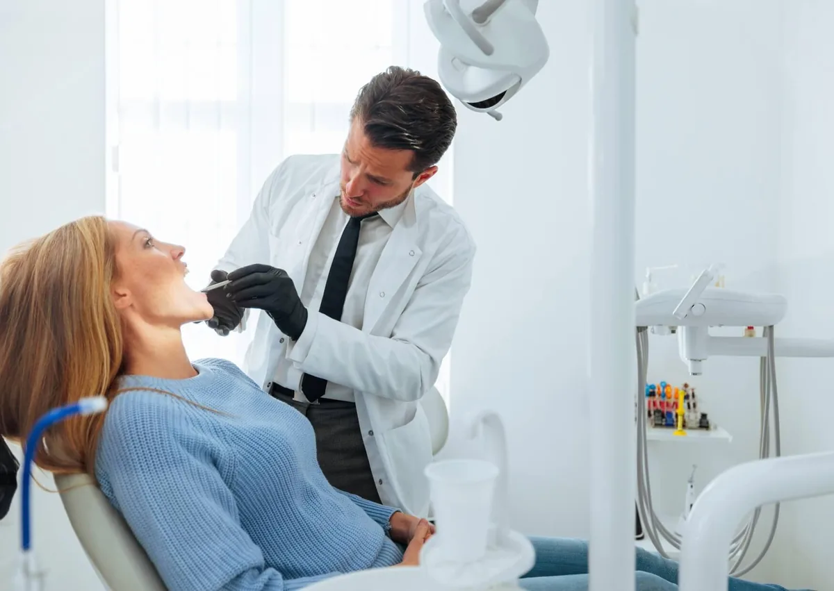Dentist examining a patient’s bite to determine the right treatment for correcting an overbite.