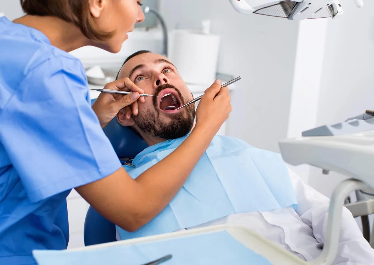 Orthodontist examining a patient to determine whether a palatal expander is needed.