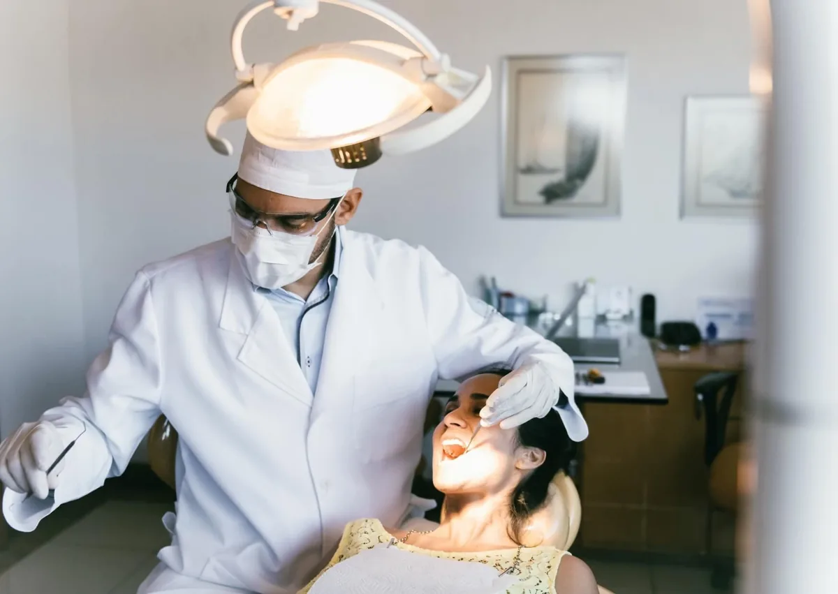 Dentist examining an adult patient to determine whether a palatal expander is appropriate.
